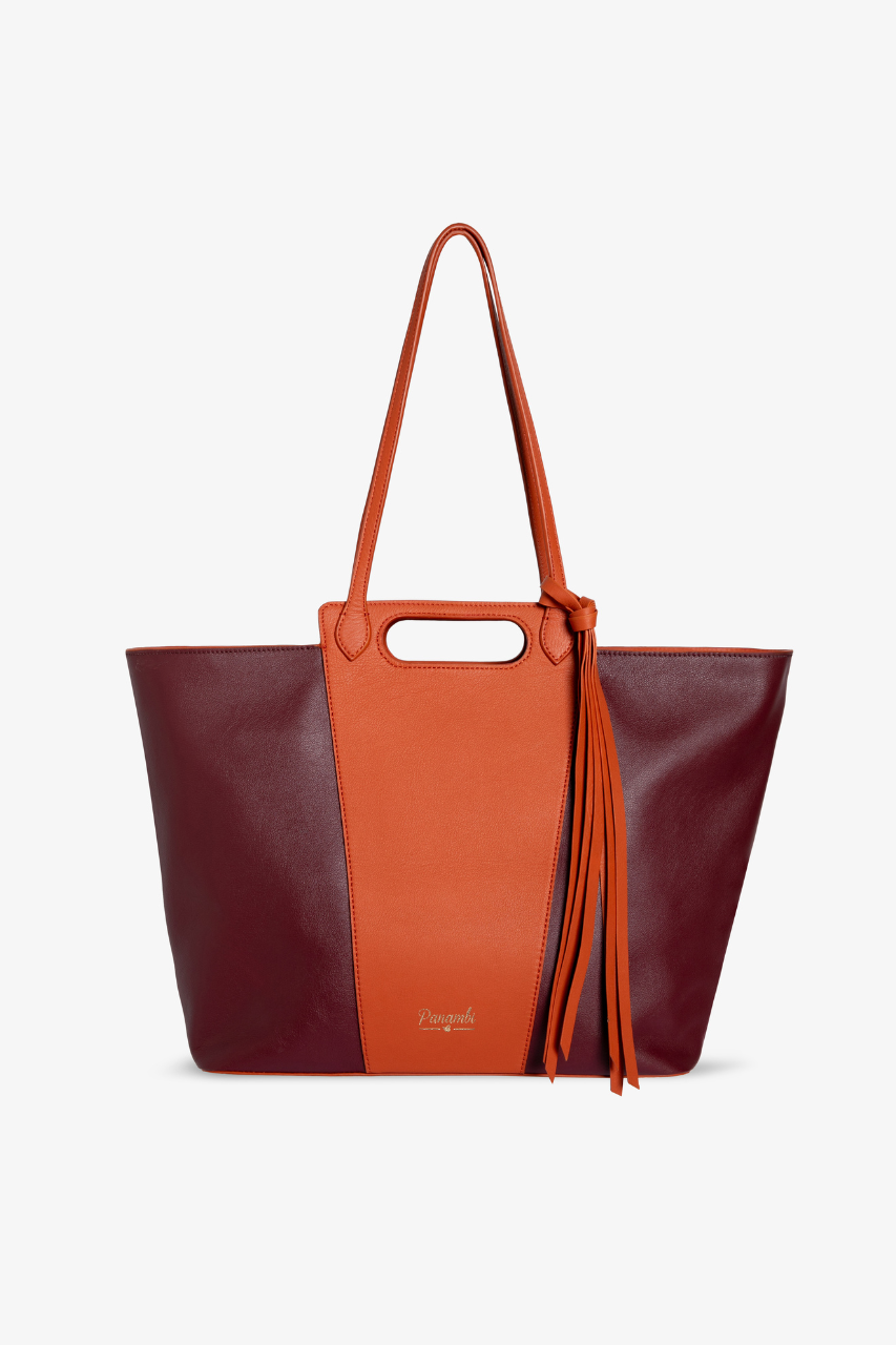 Nuestro nuevo bolso Naelle bicolor esta elaborado en piel de alta calidad en color burdeos y Naranja, tiene cierre con cremallera dorada. bolsillo interior y gran capacidad. Es el bolso perfecto para darle un toque a tus look de oficinas o casual