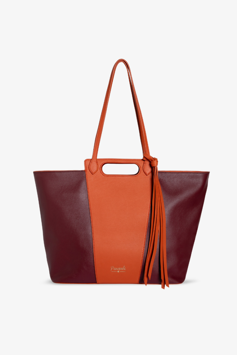 Nuestro nuevo bolso Naelle bicolor esta elaborado en piel de alta calidad en color burdeos y Naranja, tiene cierre con cremallera dorada. bolsillo interior y gran capacidad. Es el bolso perfecto para darle un toque a tus look de oficinas o casual 